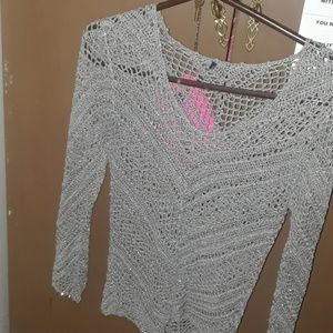 A fishnet type long sleeved shirt